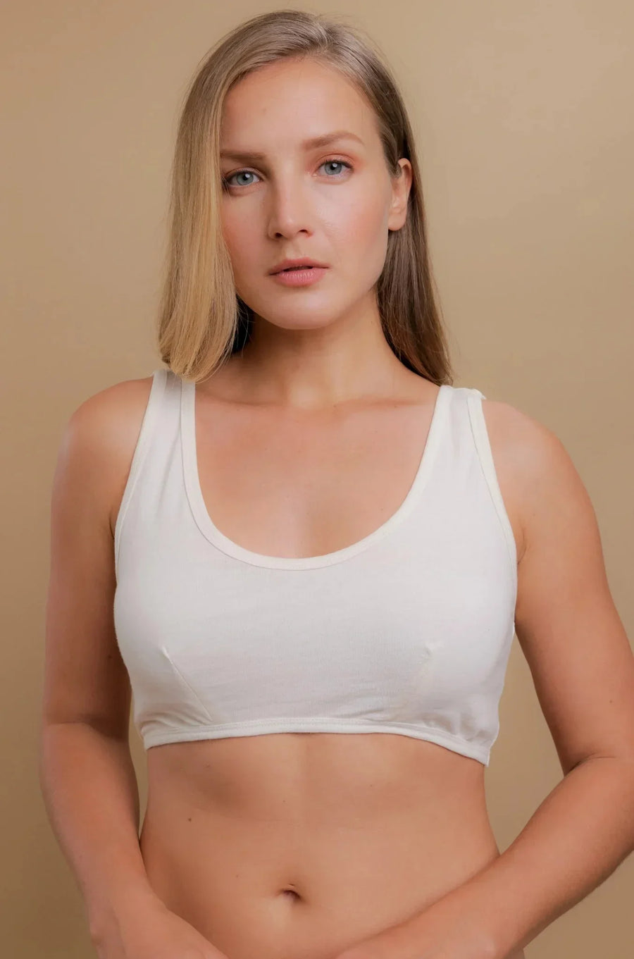 Woman wearing a natural-colored organic cotton wireless bra, ideal for sensitive skin