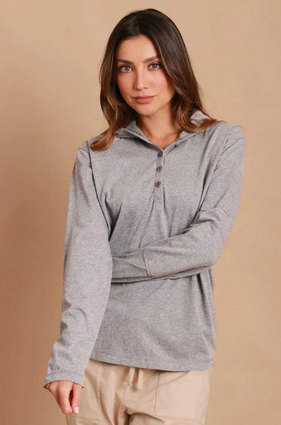 Woman wearing a long-sleeve grey organic cotton polo shirt for sensitive skin