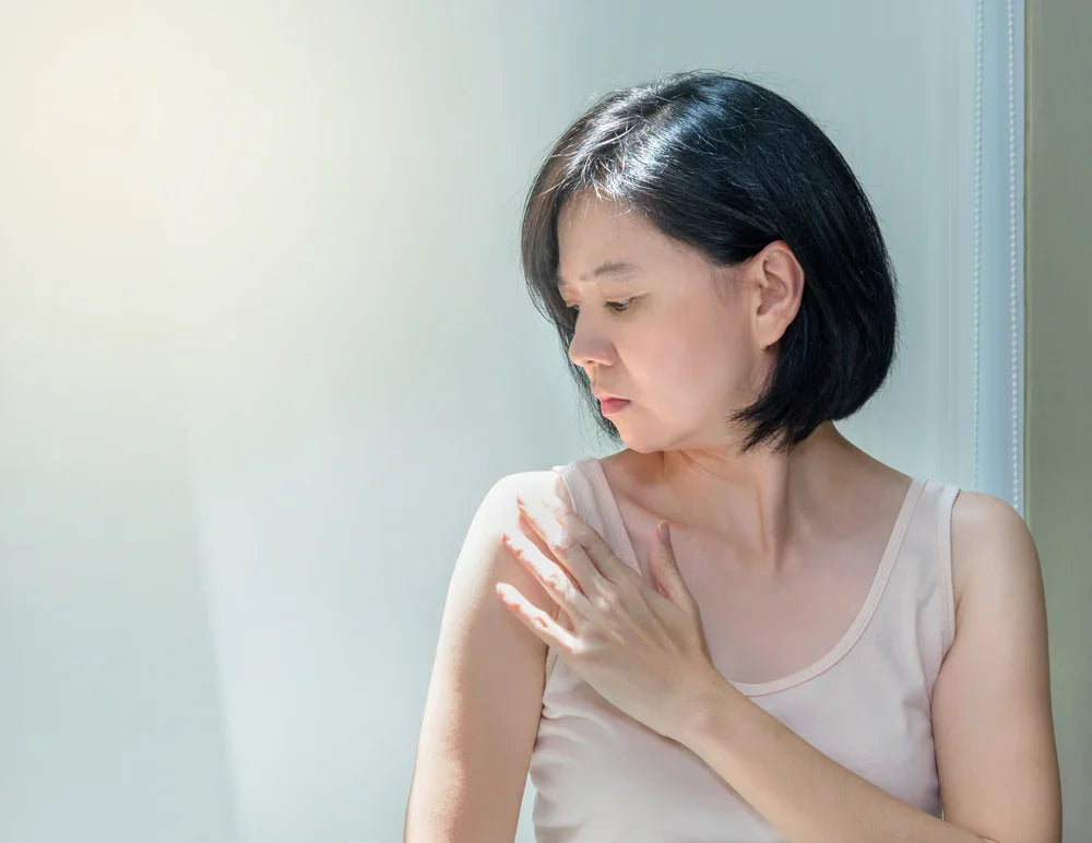 Woman with sensitive skin wearing organic cotton tank top under natural light