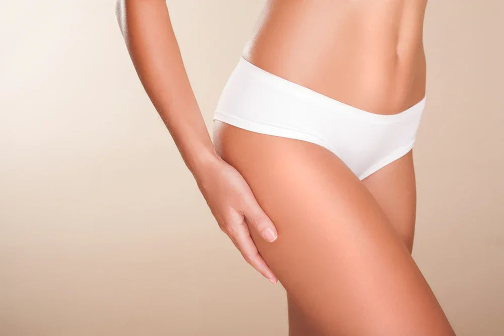 Woman wearing white hypoallergenic cotton underwear on neutral background
