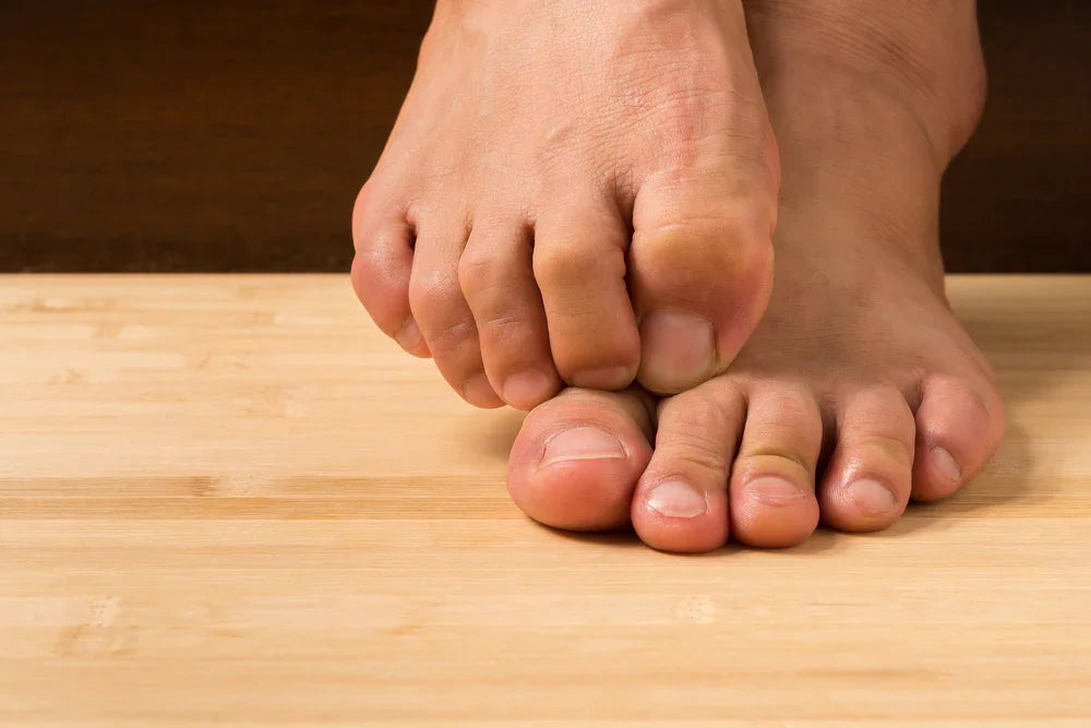 Bare feet on wooden floor, toes scratching, skin irritation, allergy-free apparel concept