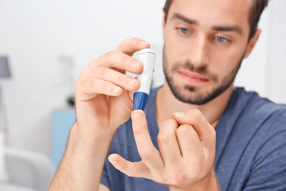 Man testing blood sugar with glucose meter, allergy-free hypoallergenic apparel concept