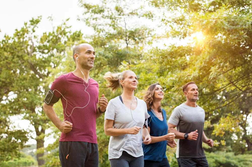 Group of adults jogging outdoors in breathable allergy-free apparel by Cottonique