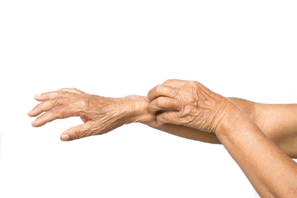 Senior person scratching itchy forearm, allergy-free apparel concept, white background