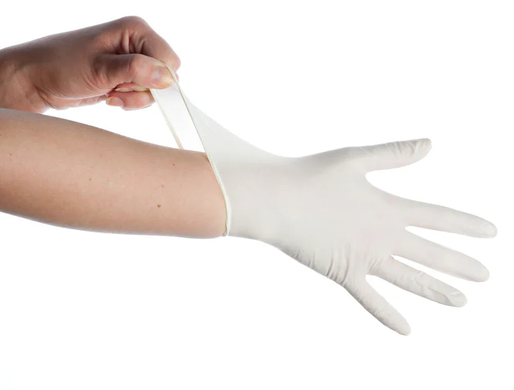 Hand putting on a white hypoallergenic glove, sensitive skin protection, isolated background