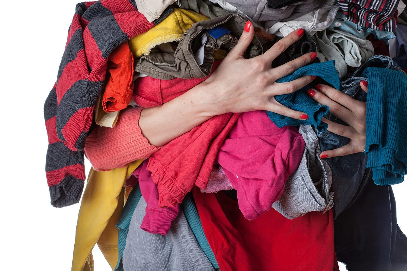 Person holding a large pile of colorful cotton clothes, allergy-free apparel concept