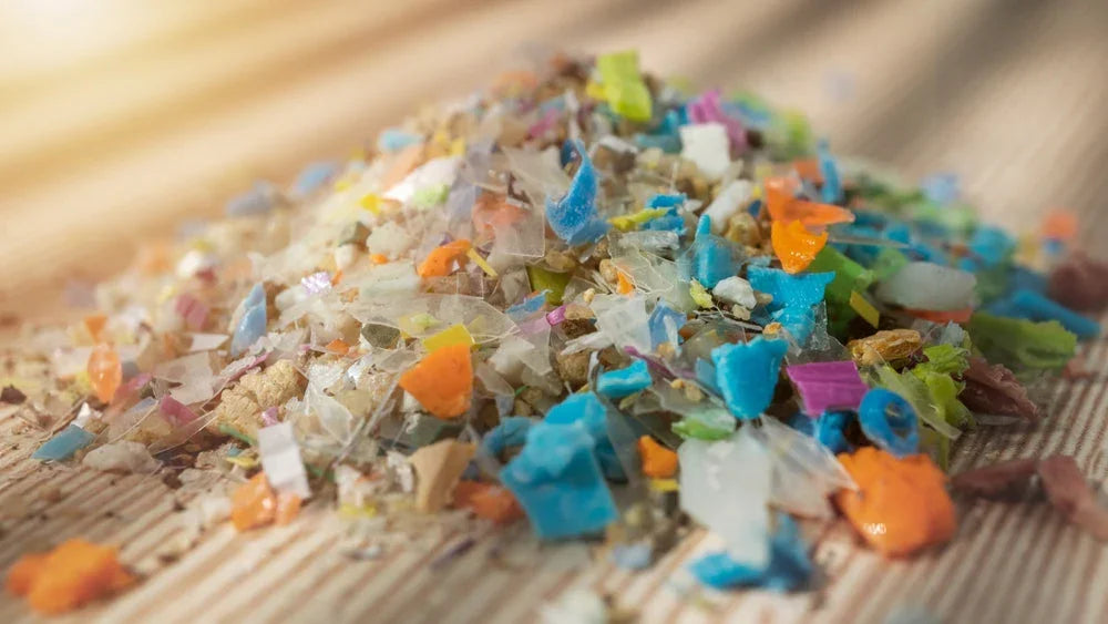 Close-up of multicolored microplastics on a fabric surface, environmental pollution concept
