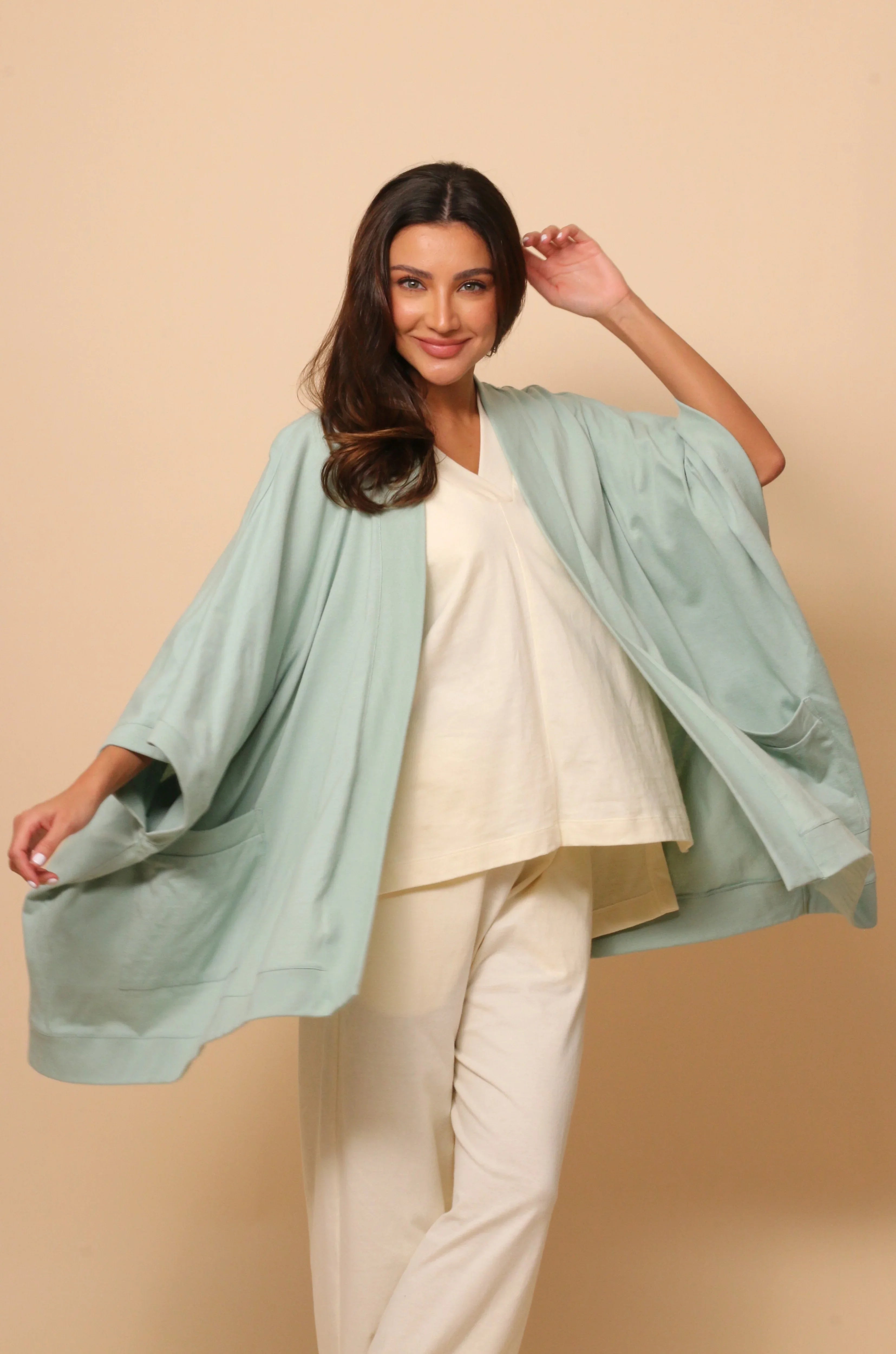 Woman wearing allergy-friendly organic cotton loungewear in light pastel colors