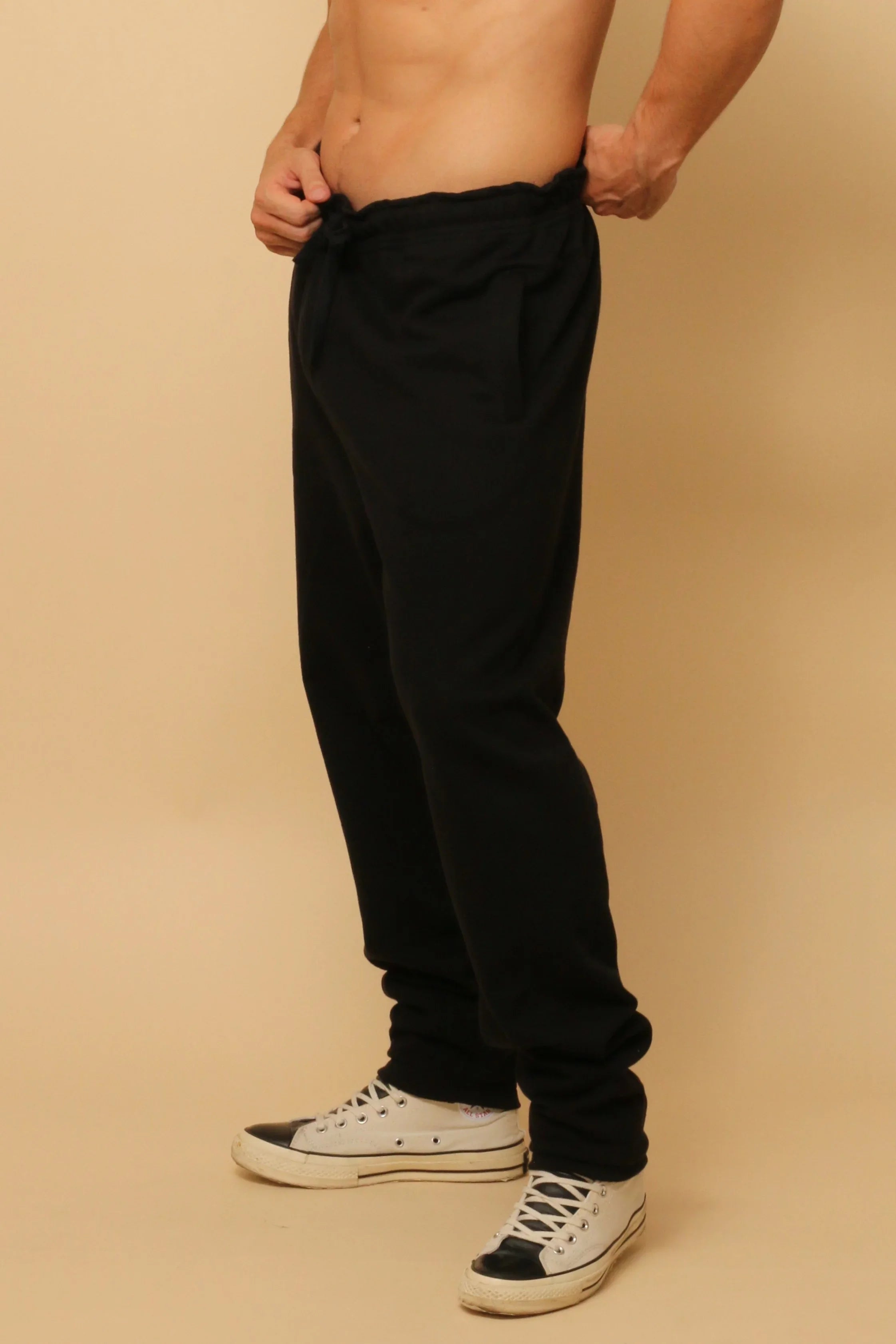 Man wearing black organic cotton drawstring sweatpants for sensitive skin