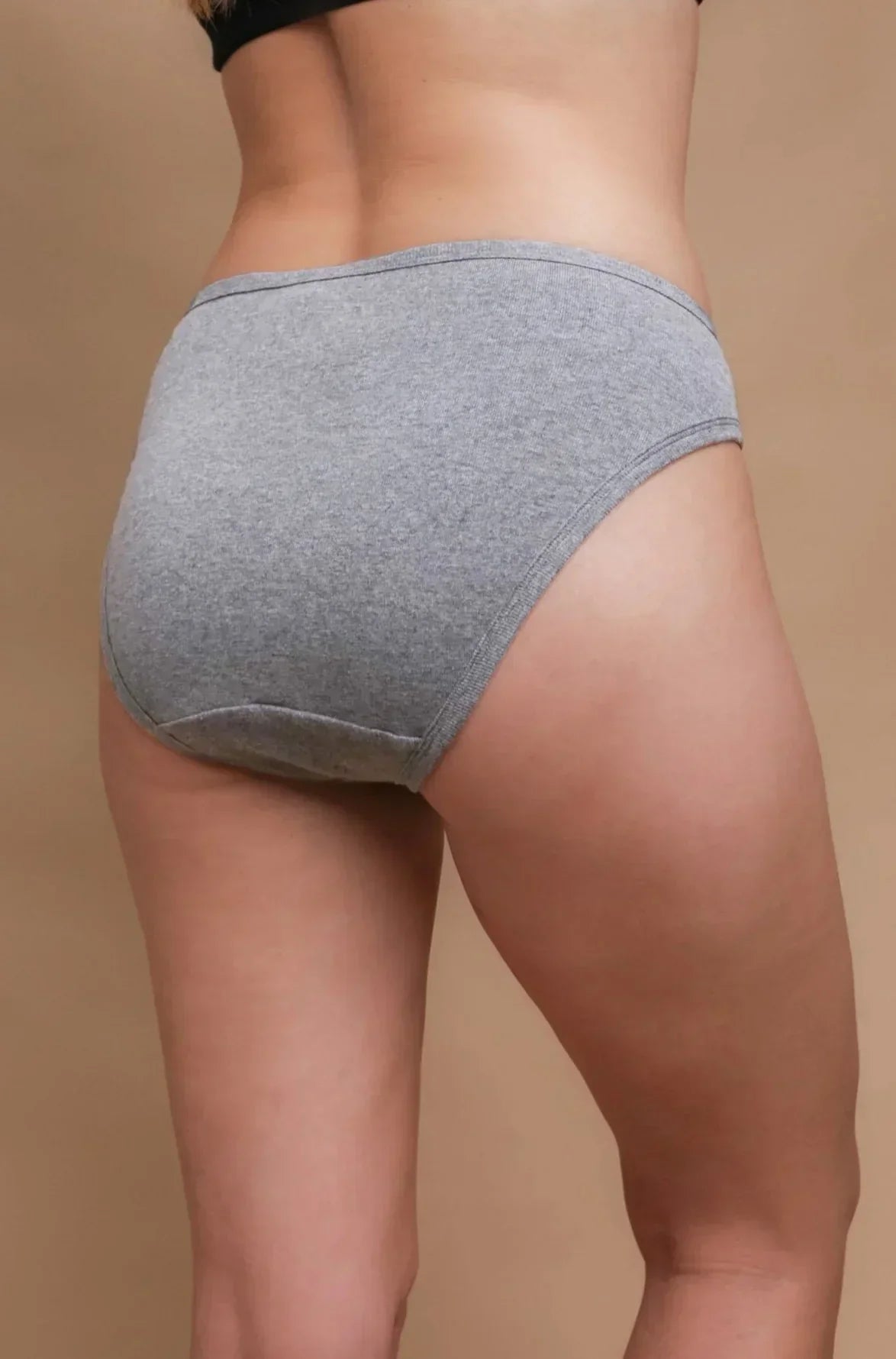 Woman wearing grey hypoallergenic cotton underwear from Cottonique, viewed from the back