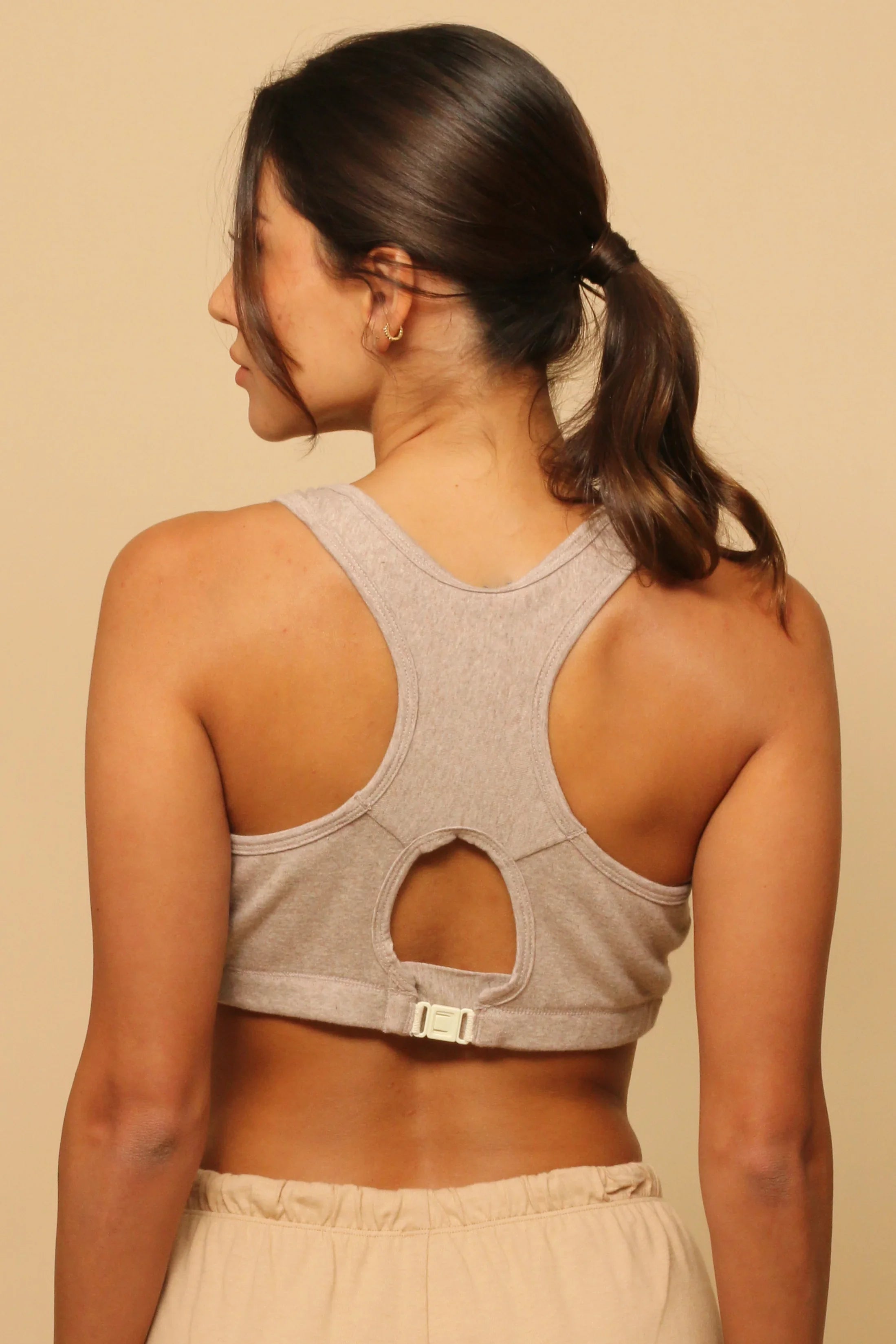 Woman wearing a hypoallergenic cotton bra from Cottonique, racerback style, back view