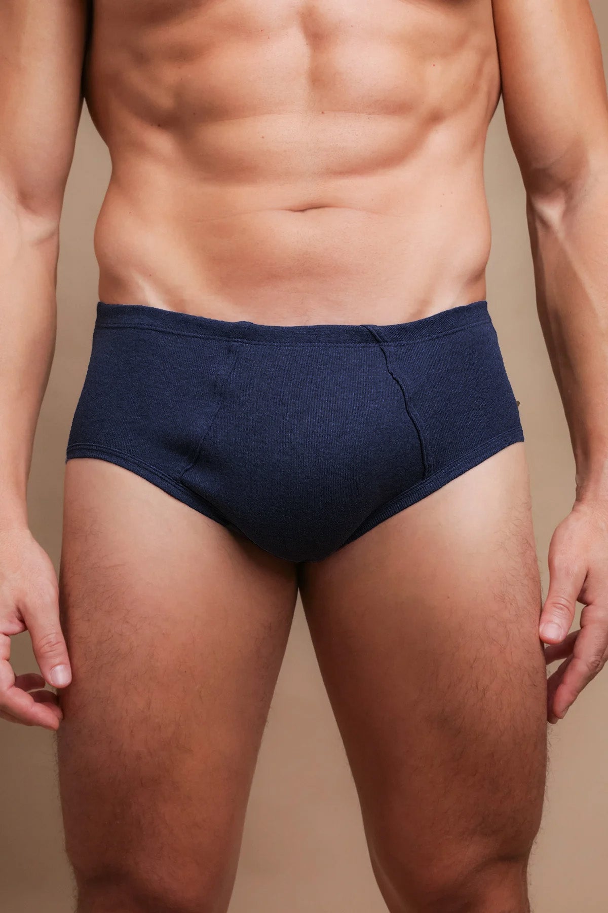 Men’s navy blue hypoallergenic cotton briefs by Cottonique, shown on model torso