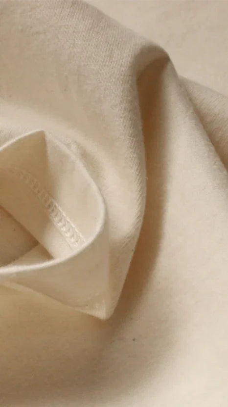 Close-up of natural organic cotton fabric, undyed and soft, ideal for sensitive skin