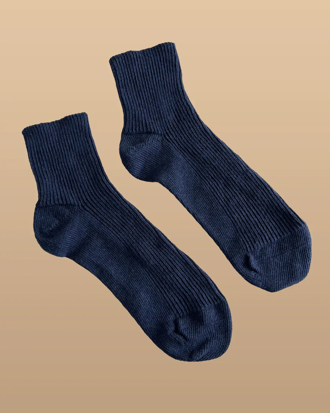 Navy hypoallergenic cotton crew socks from Cottonique on beige background