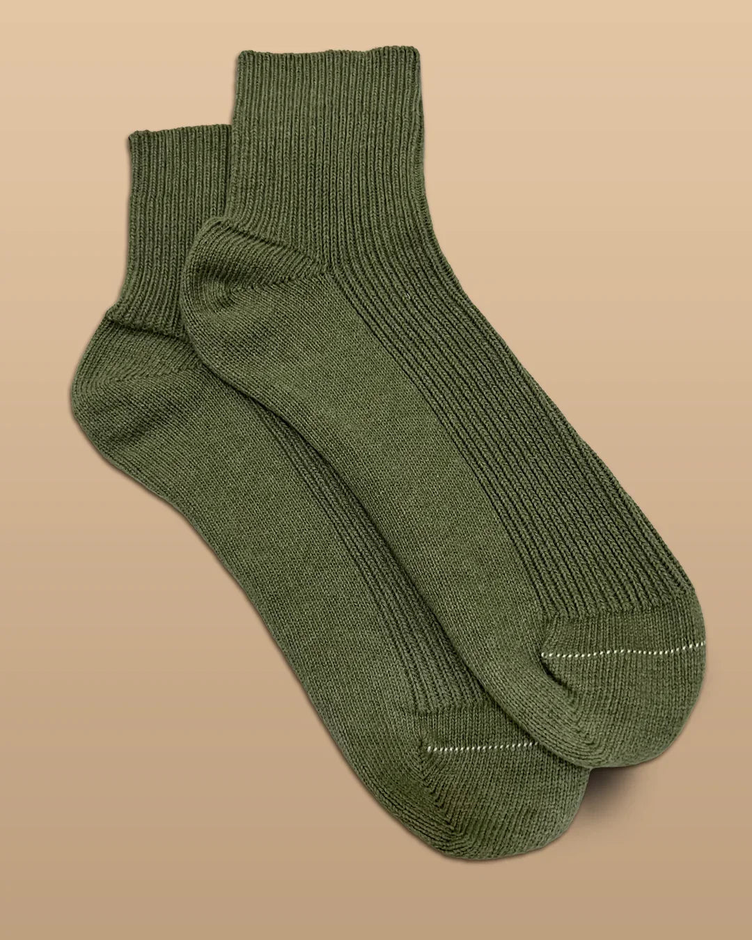 Olive green hypoallergenic cotton socks on a beige background, Cottonique allergy-free apparel