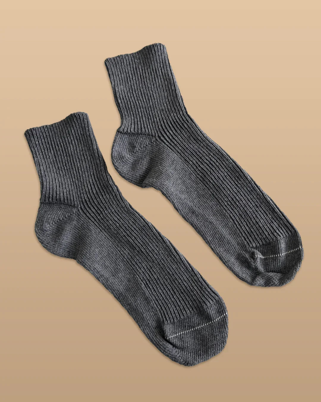 Gray hypoallergenic cotton socks for sensitive skin on neutral background