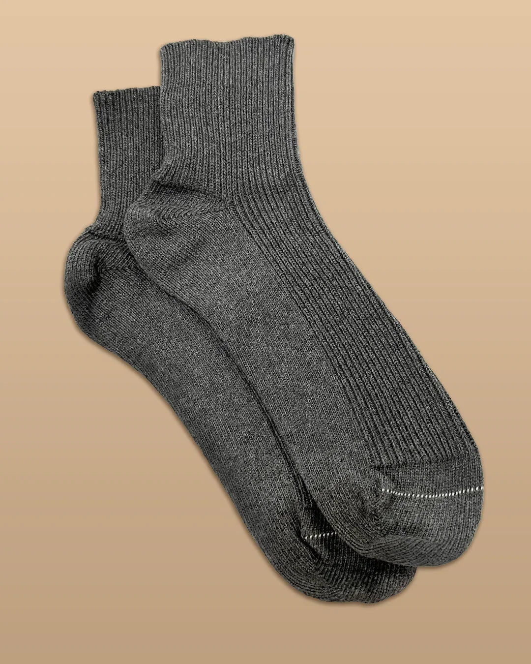Allergy-free gray cotton crew socks from Cottonique on tan background