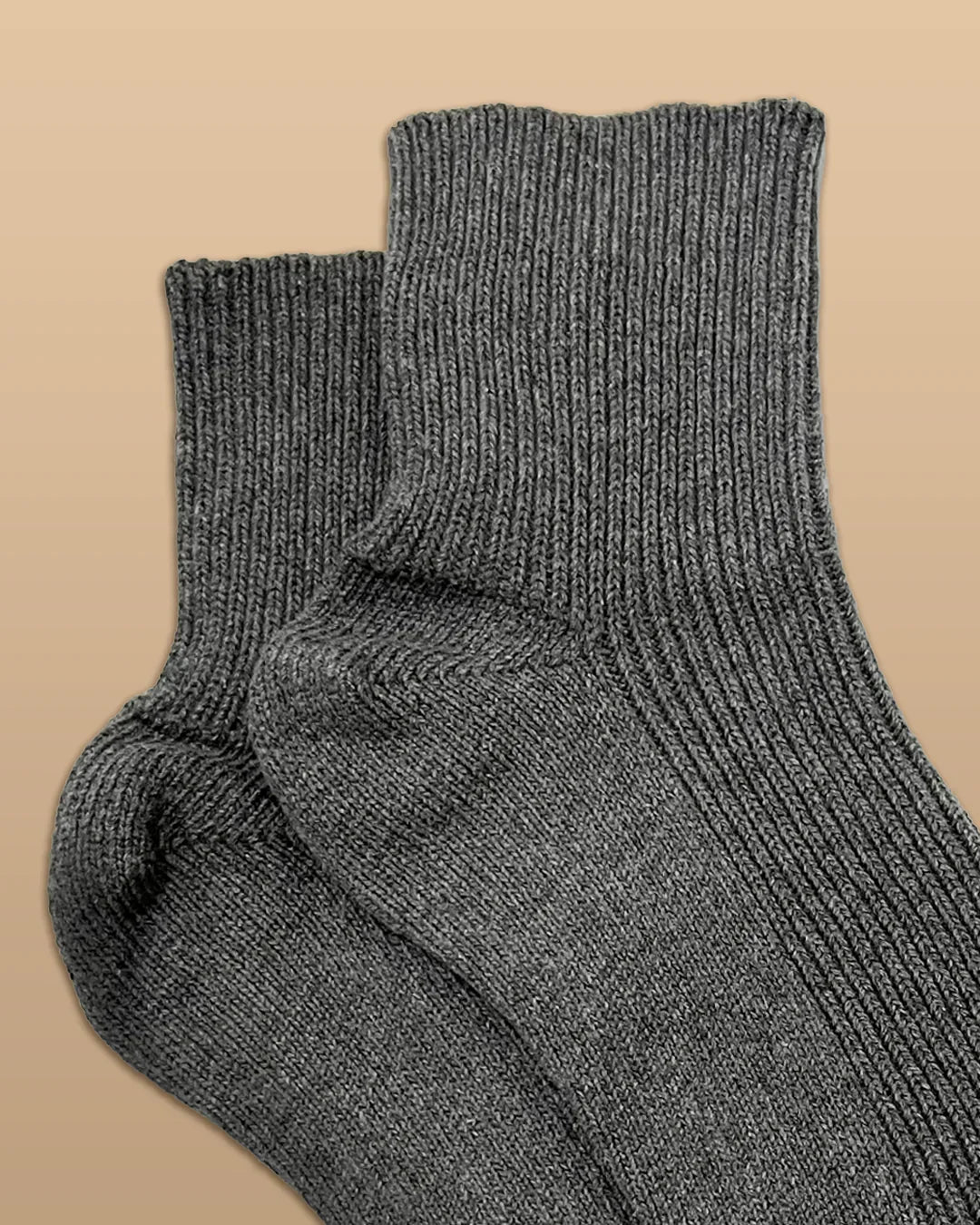 Gray hypoallergenic cotton socks from Cottonique on a beige background