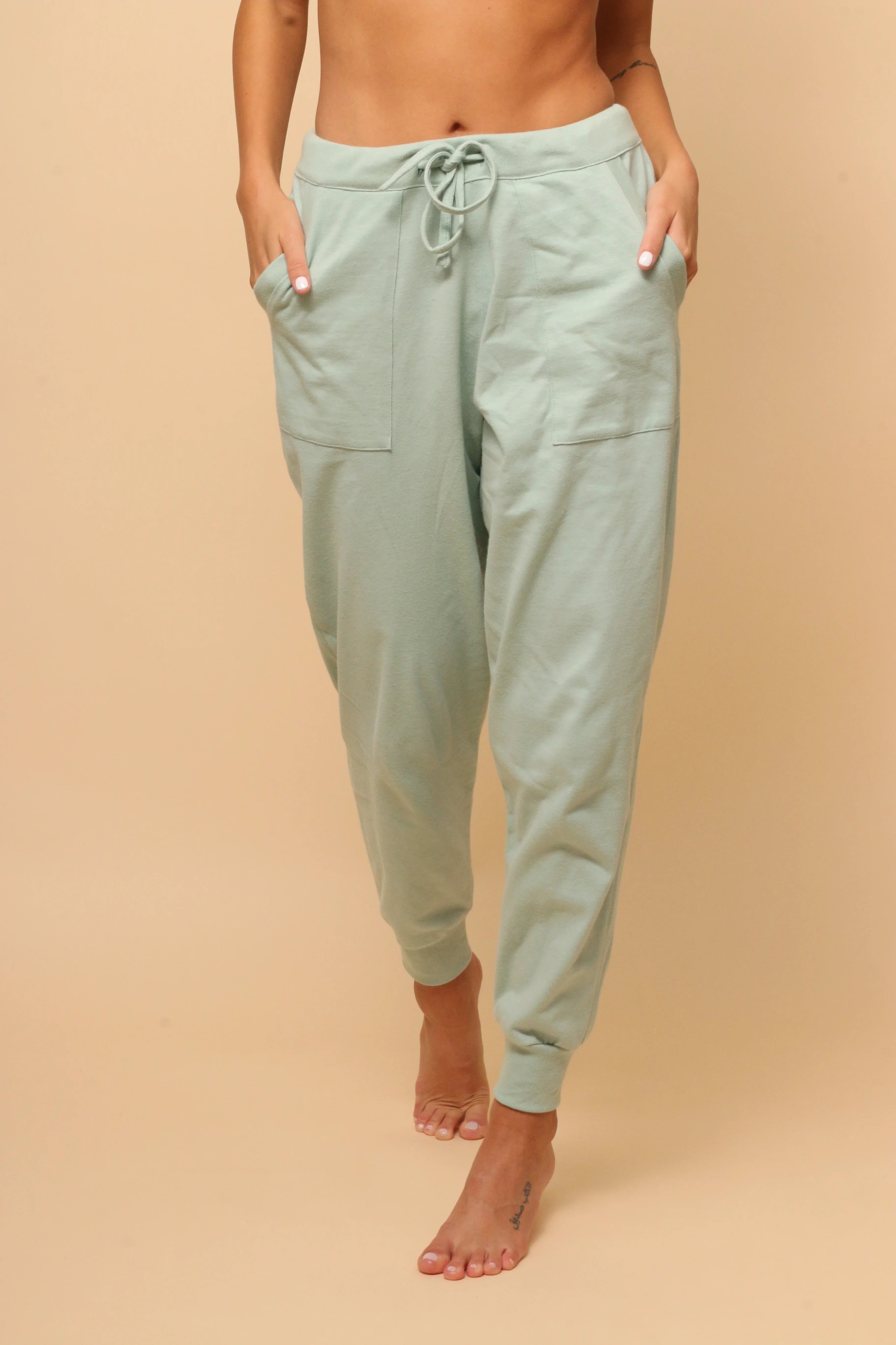 Woman wearing light green hypoallergenic Cottonique jogger pants with pockets