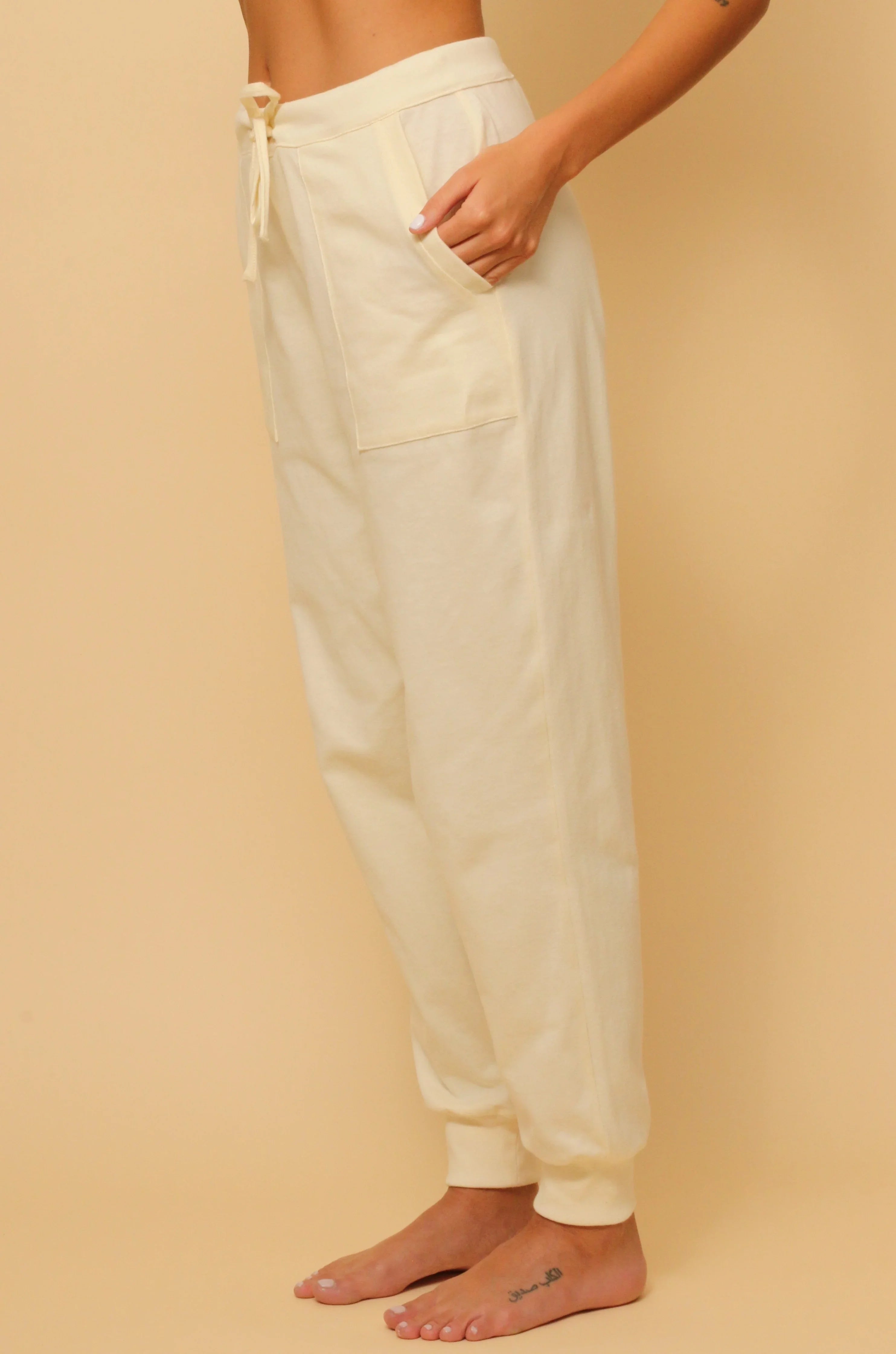 Woman wearing Cottonique allergy-free natural cotton jogger pants with pockets