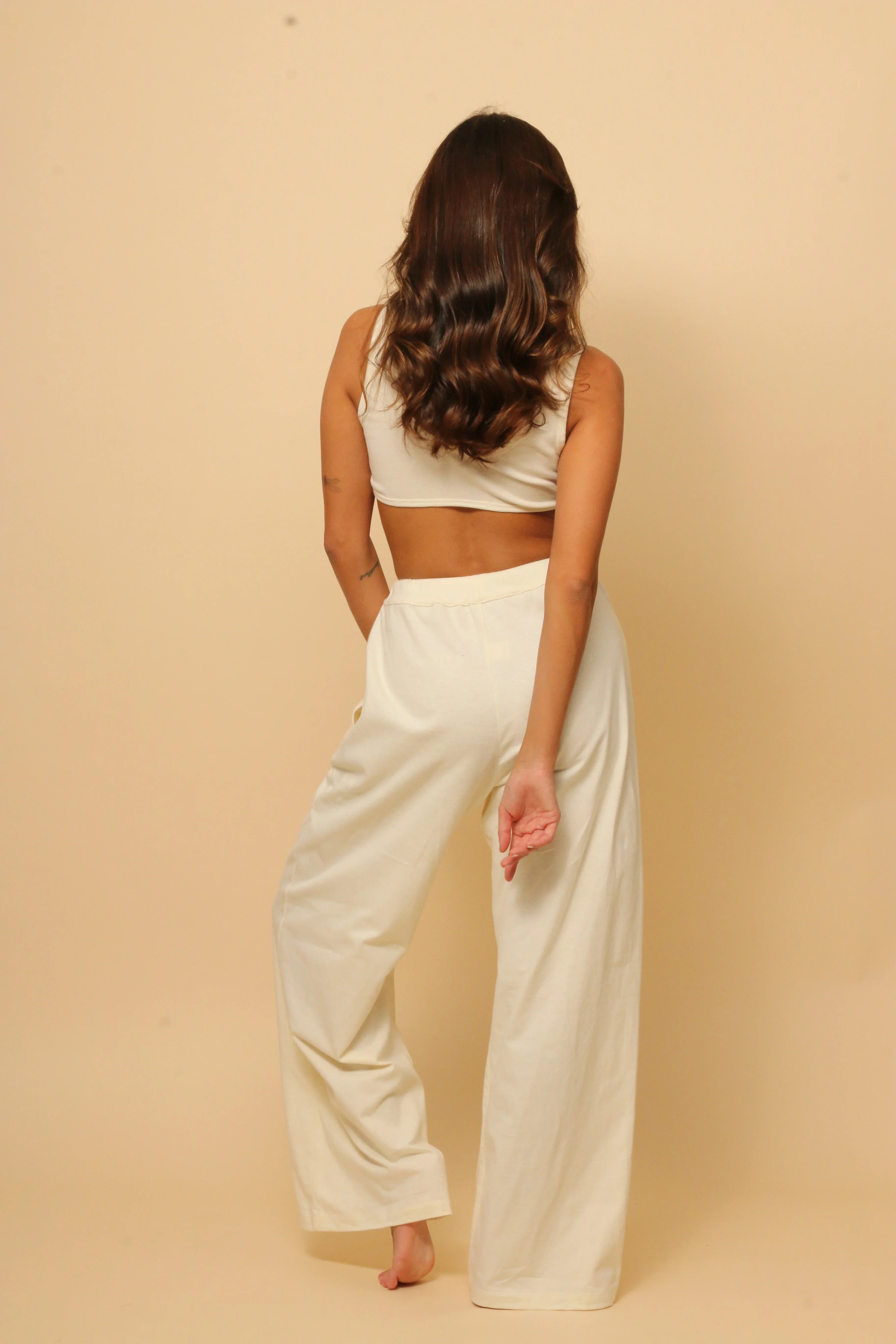 Woman wearing allergy-free Cottonique hypoallergenic loungewear set, back view