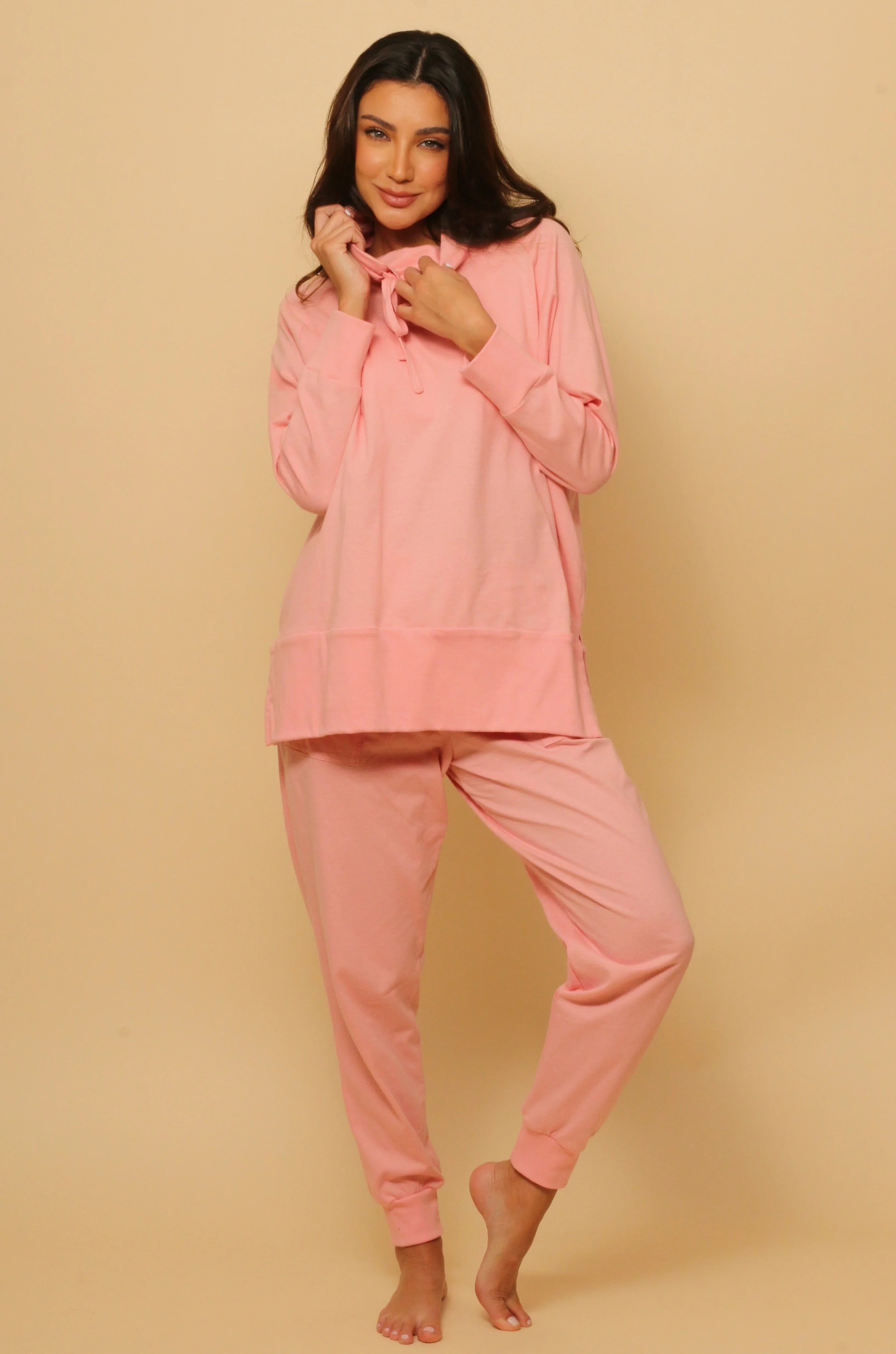 Woman wearing pink hypoallergenic Cottonique loungewear set, allergy-free apparel