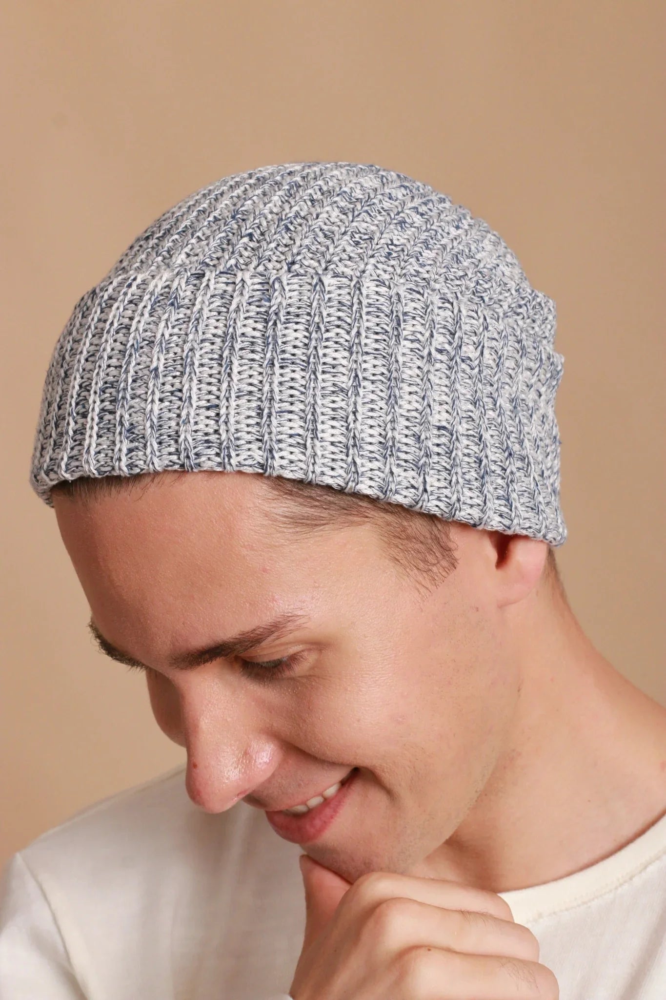 Man wearing a gray ribbed hypoallergenic cotton beanie from Cottonique, neutral background.