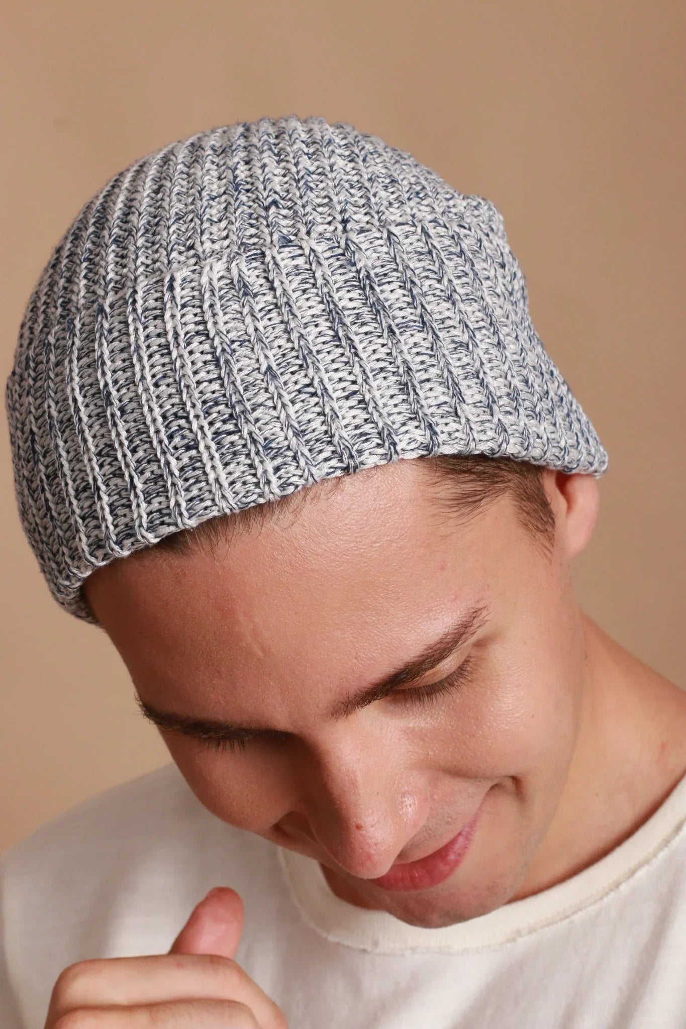 Man wearing a light blue knit hypoallergenic cotton beanie from Cottonique