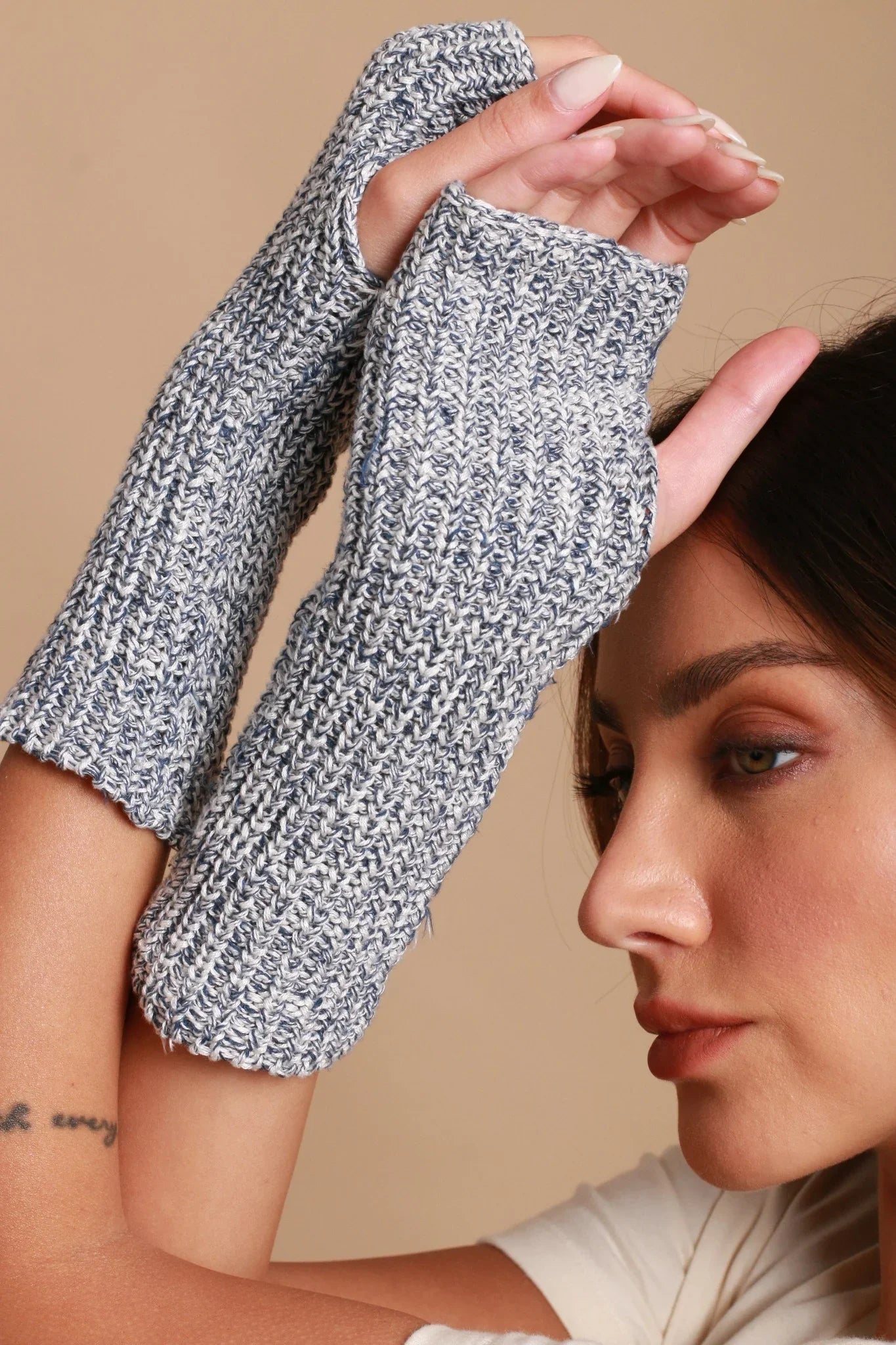 Woman wearing gray knit hypoallergenic fingerless gloves from Cottonique