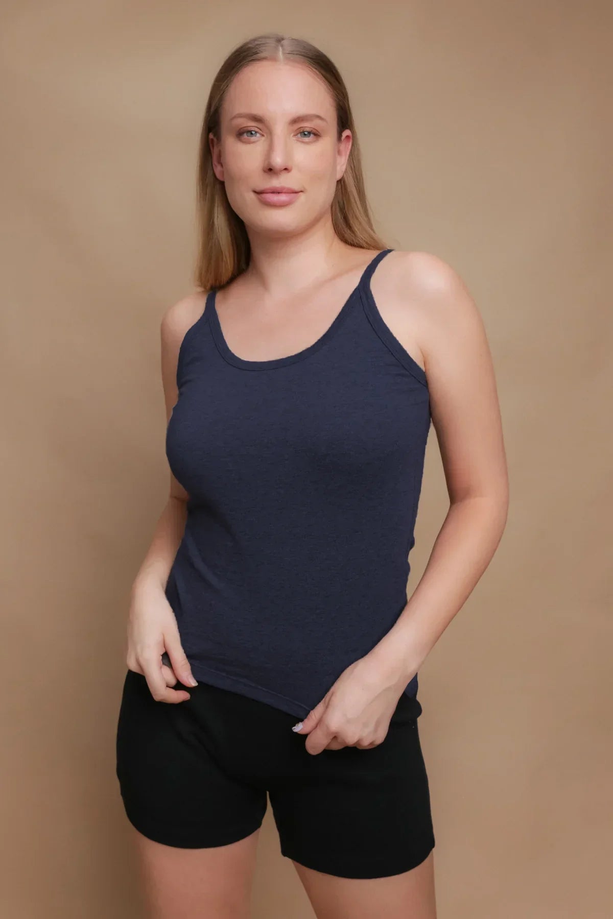 Woman wearing navy blue organic cotton camisole and black shorts for sensitive skin