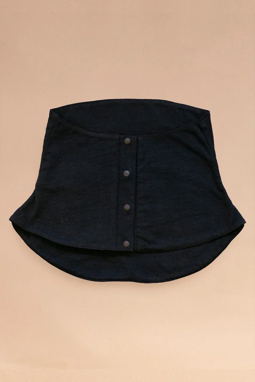 Black hypoallergenic cotton neck warmer with front snaps on neutral background