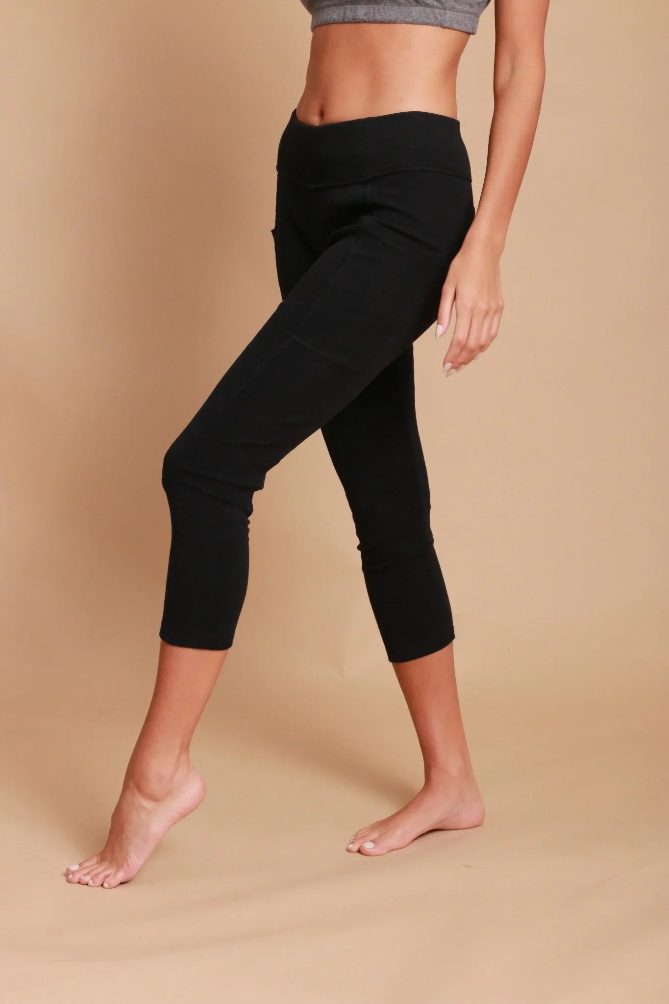 Woman wearing black organic cotton cropped leggings for sensitive skin