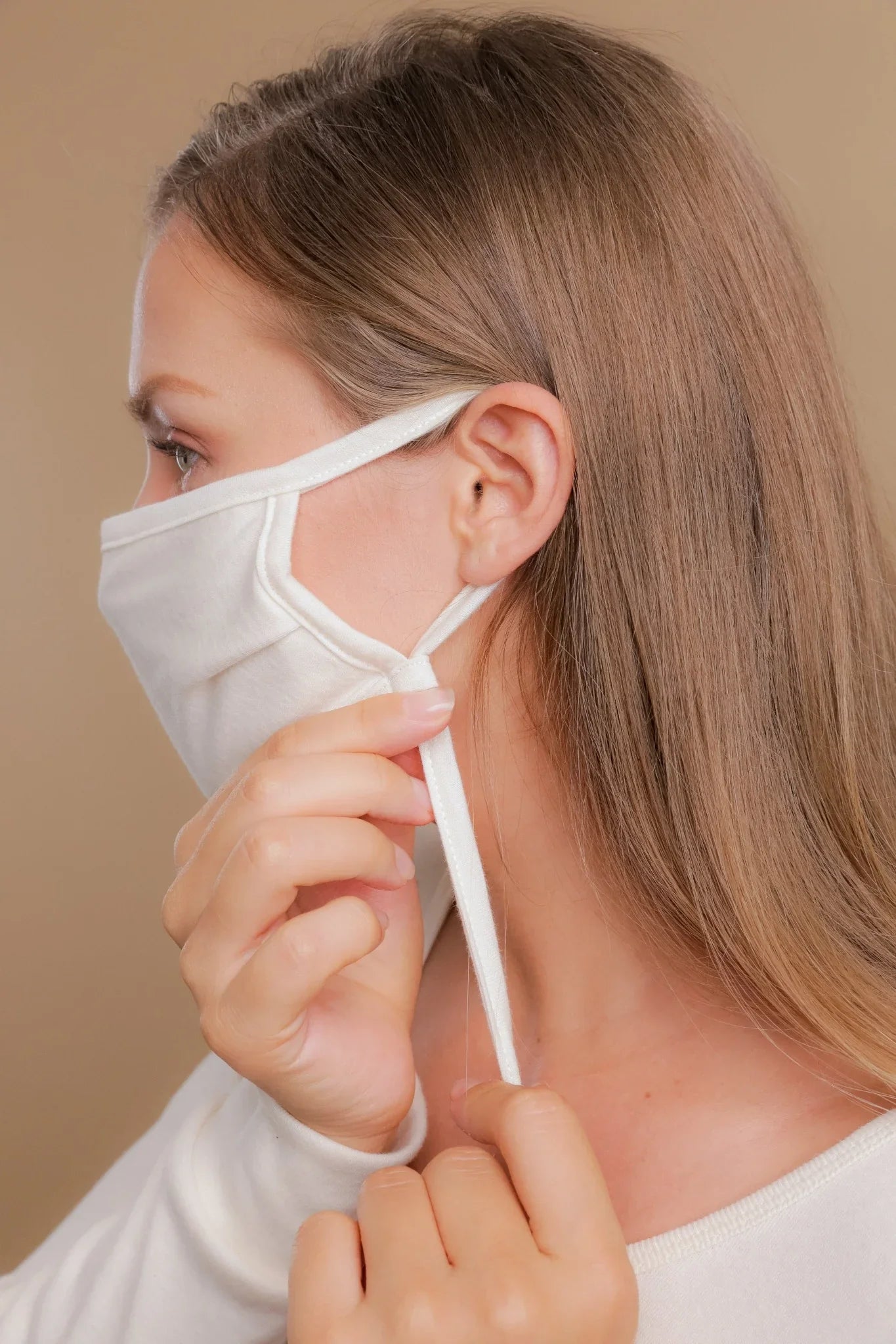 Woman adjusting hypoallergenic cotton face mask from Cottonique