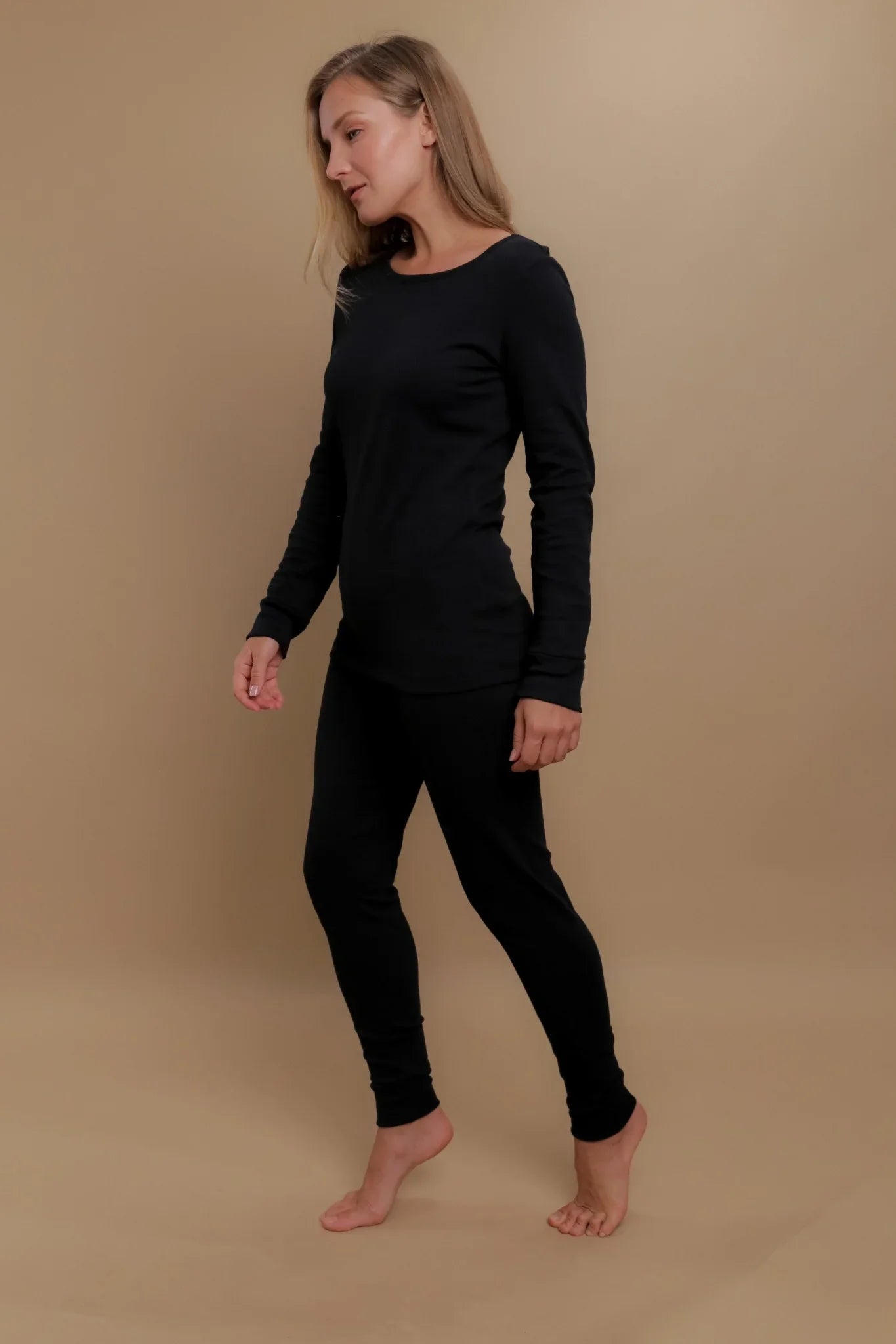 Woman wearing black hypoallergenic cotton long-sleeve top and pants, Cottonique apparel