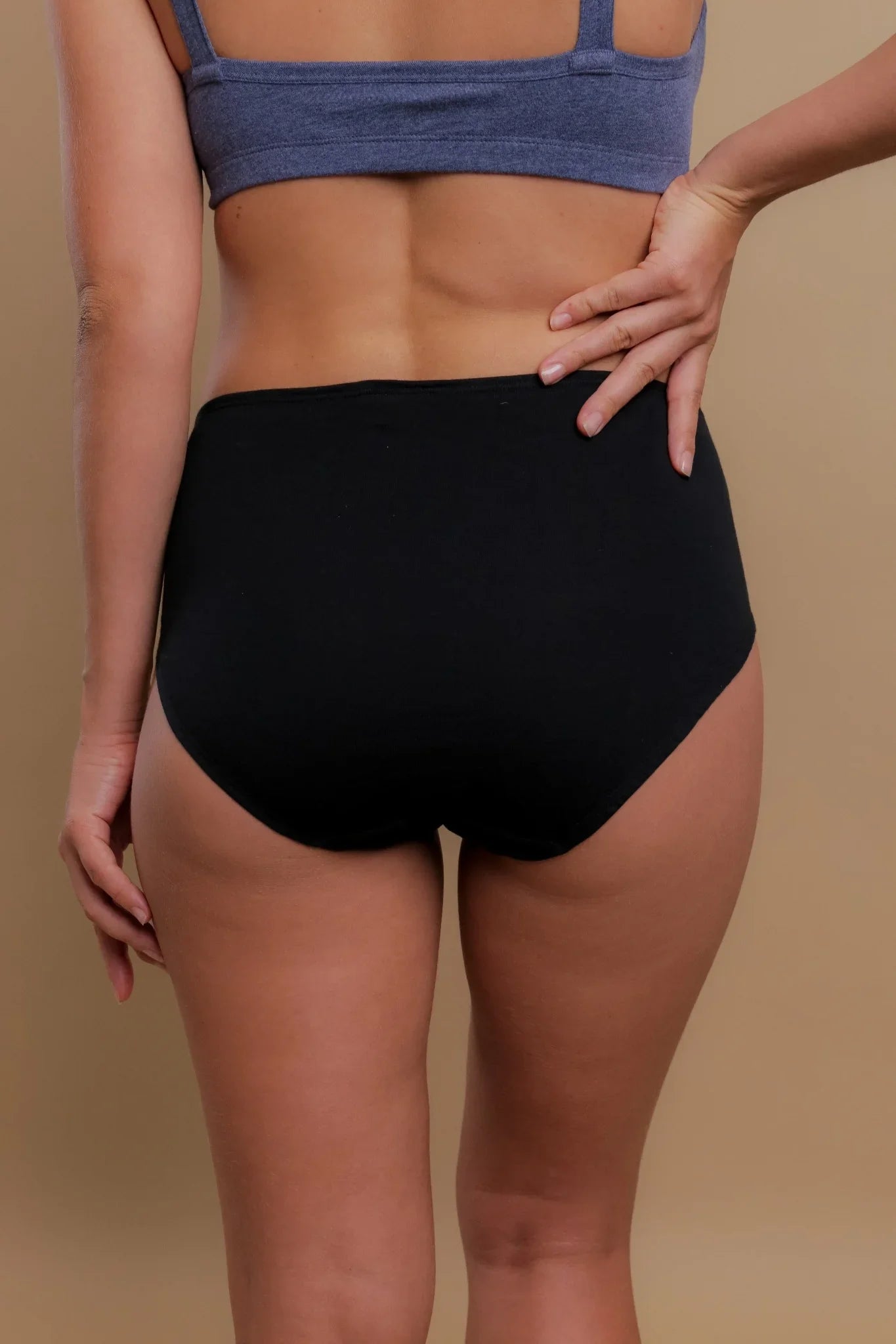 Woman wearing black high-waist hypoallergenic cotton underwear by Cottonique