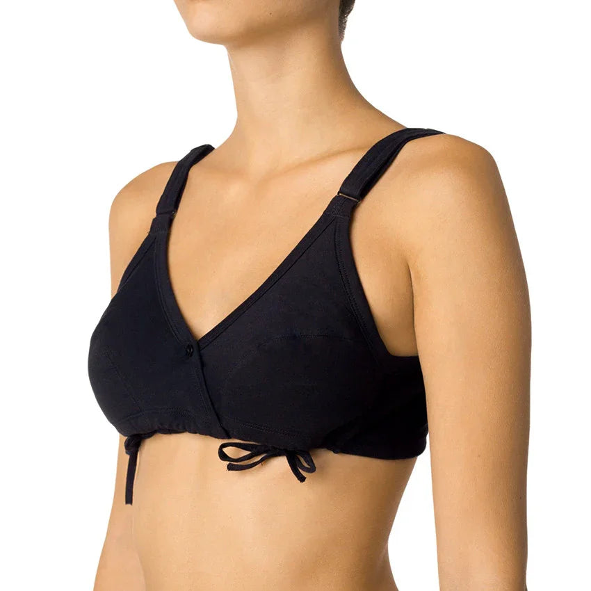 Woman wearing a black organic cotton front-tie wireless bra for sensitive skin