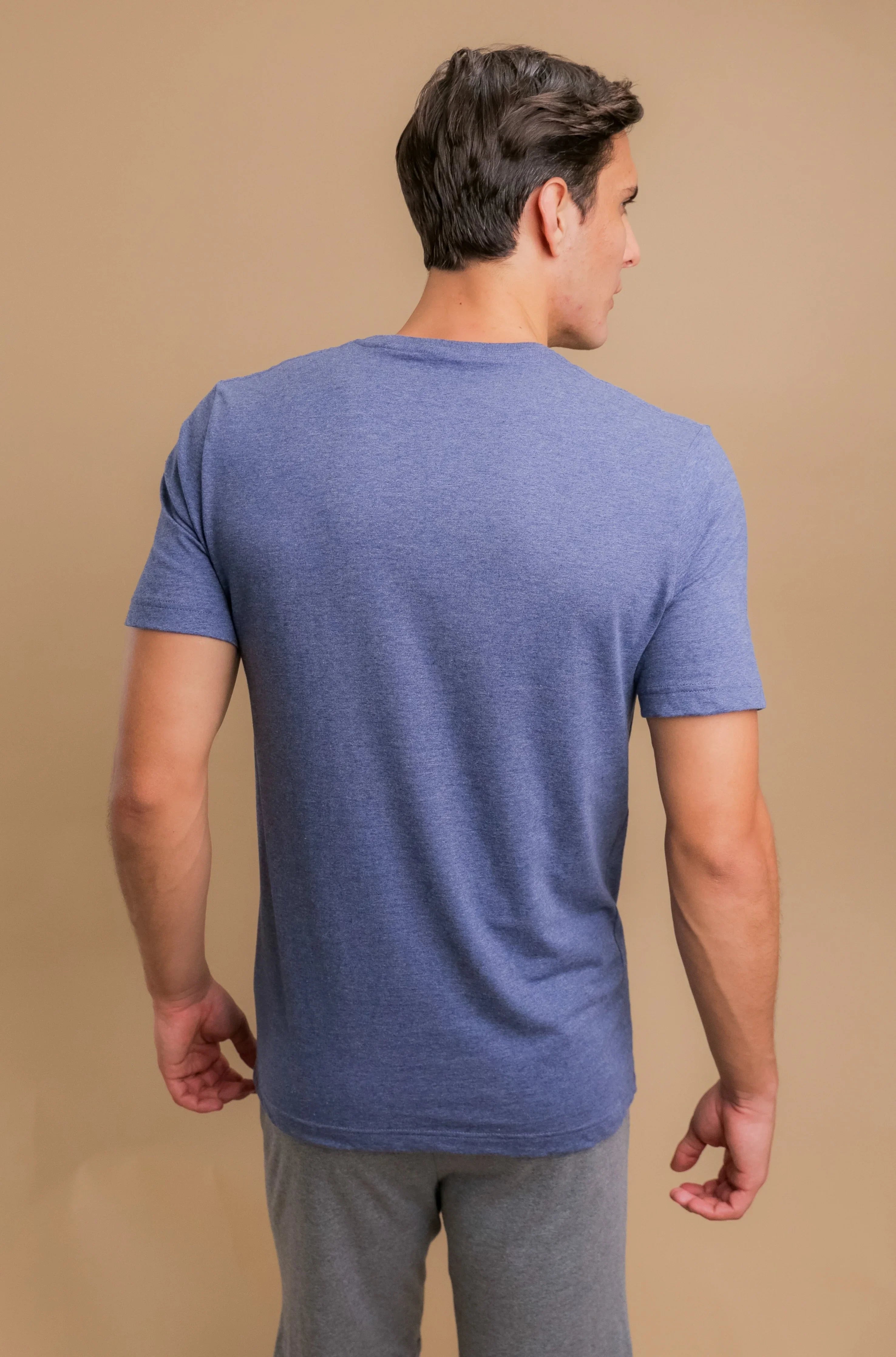 Man wearing a blue short-sleeve hypoallergenic cotton t-shirt by Cottonique, back view