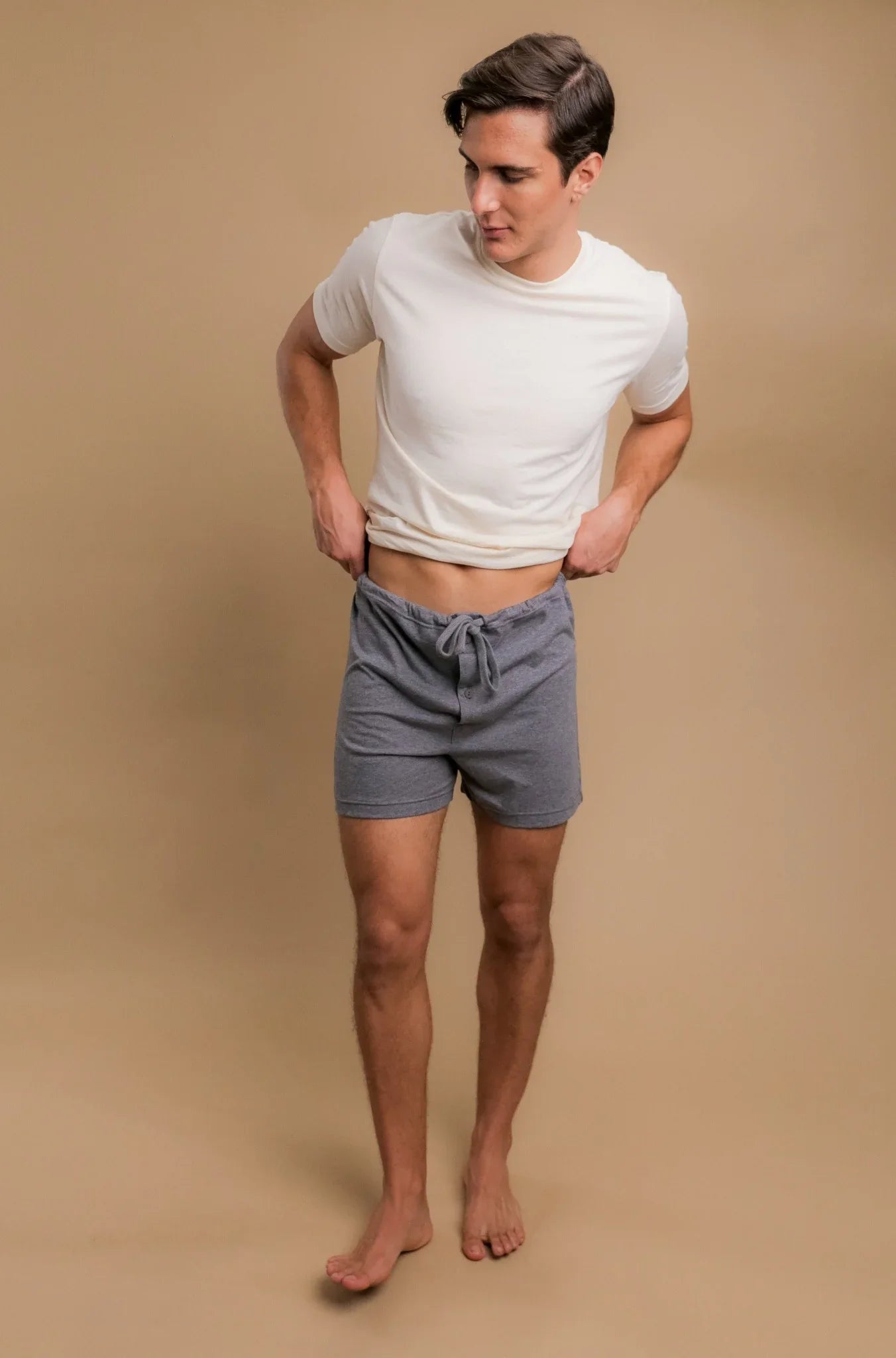 Man wearing hypoallergenic gray cotton shorts and white t-shirt from Cottonique