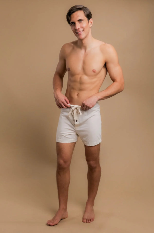 Man wearing drawstring organic cotton shorts for sensitive skin on beige background