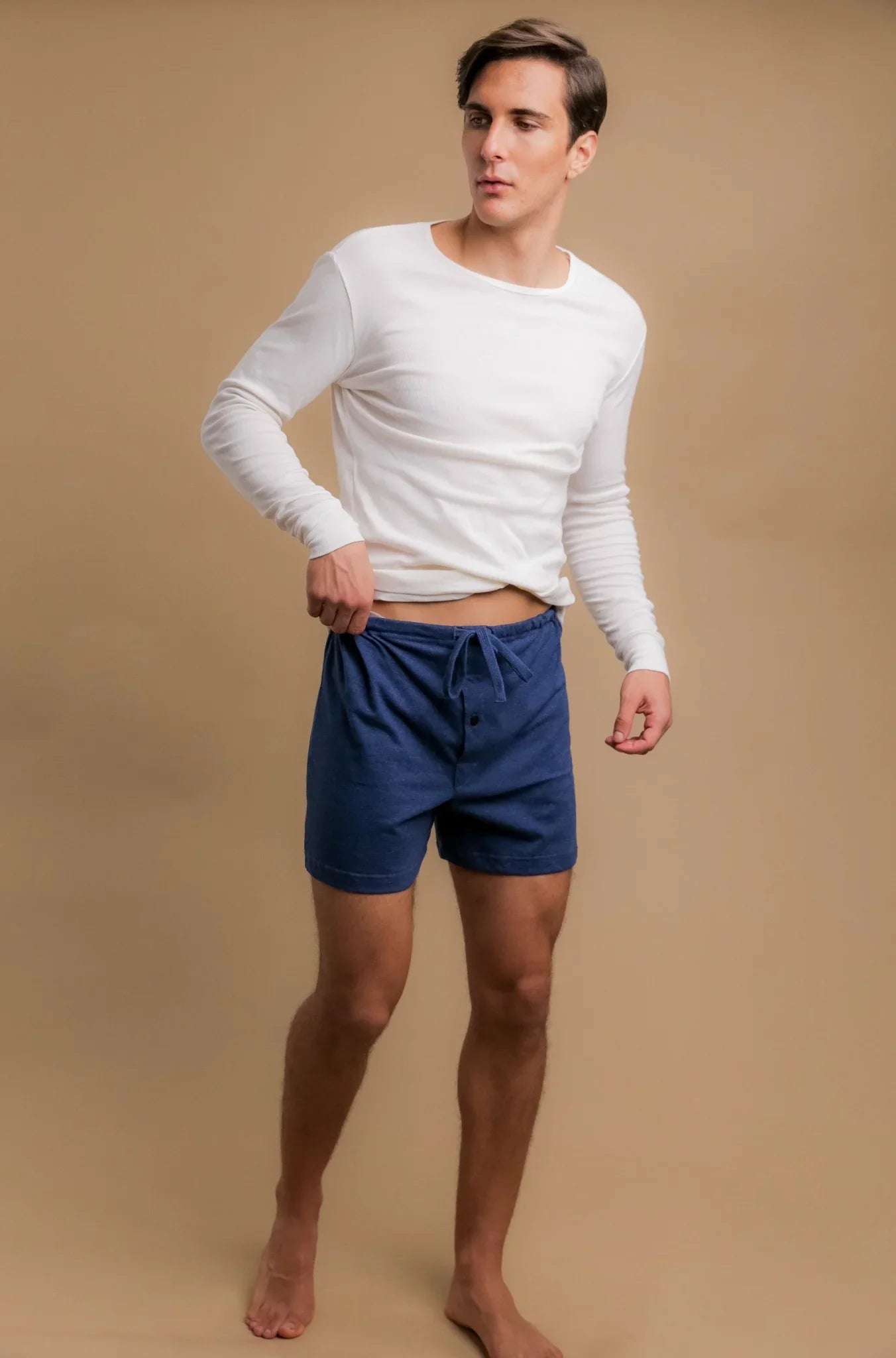Man wearing Cottonique hypoallergenic white long sleeve shirt and blue shorts