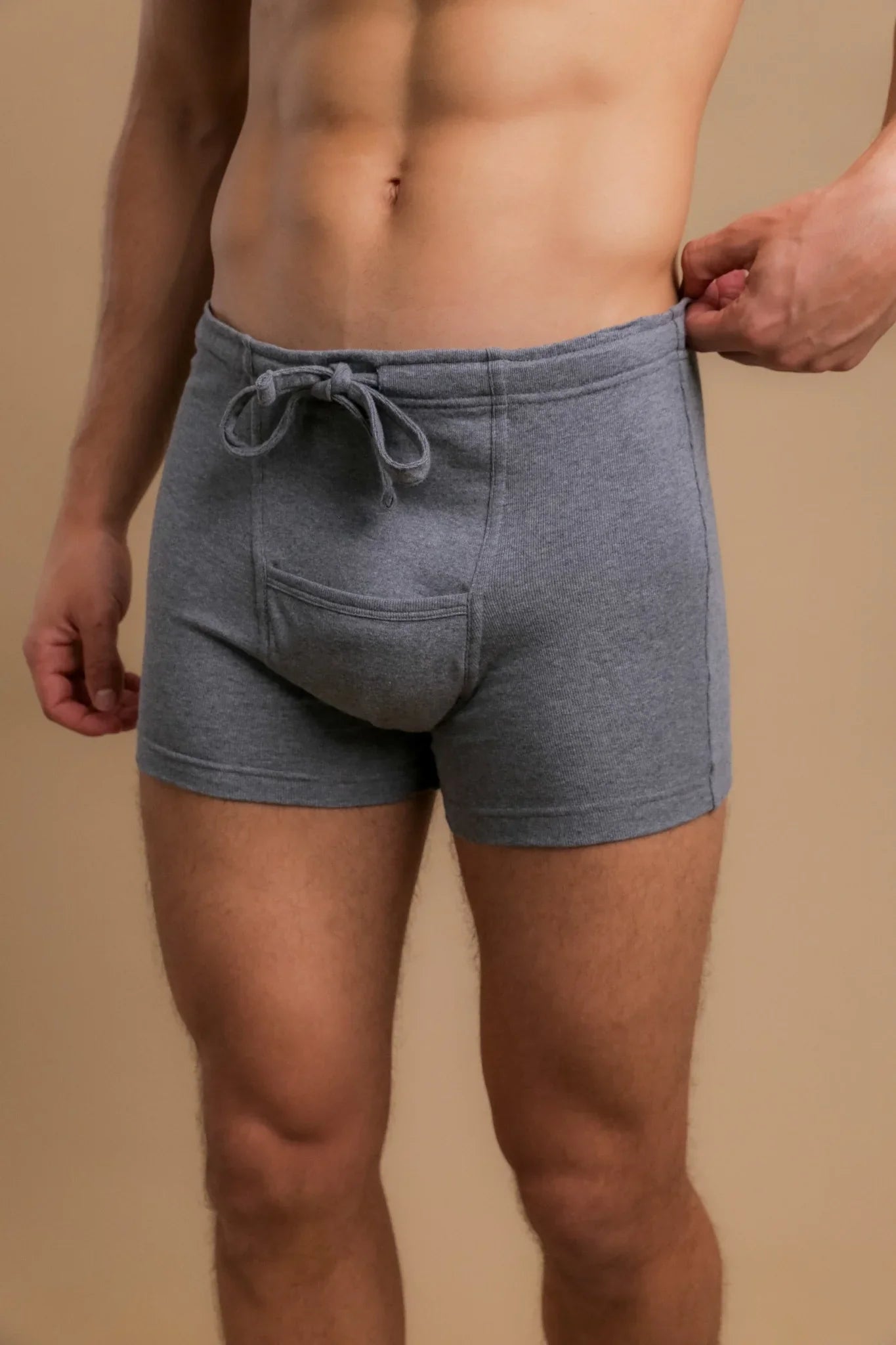 Man wearing grey organic cotton boxer shorts with drawstring for sensitive skin