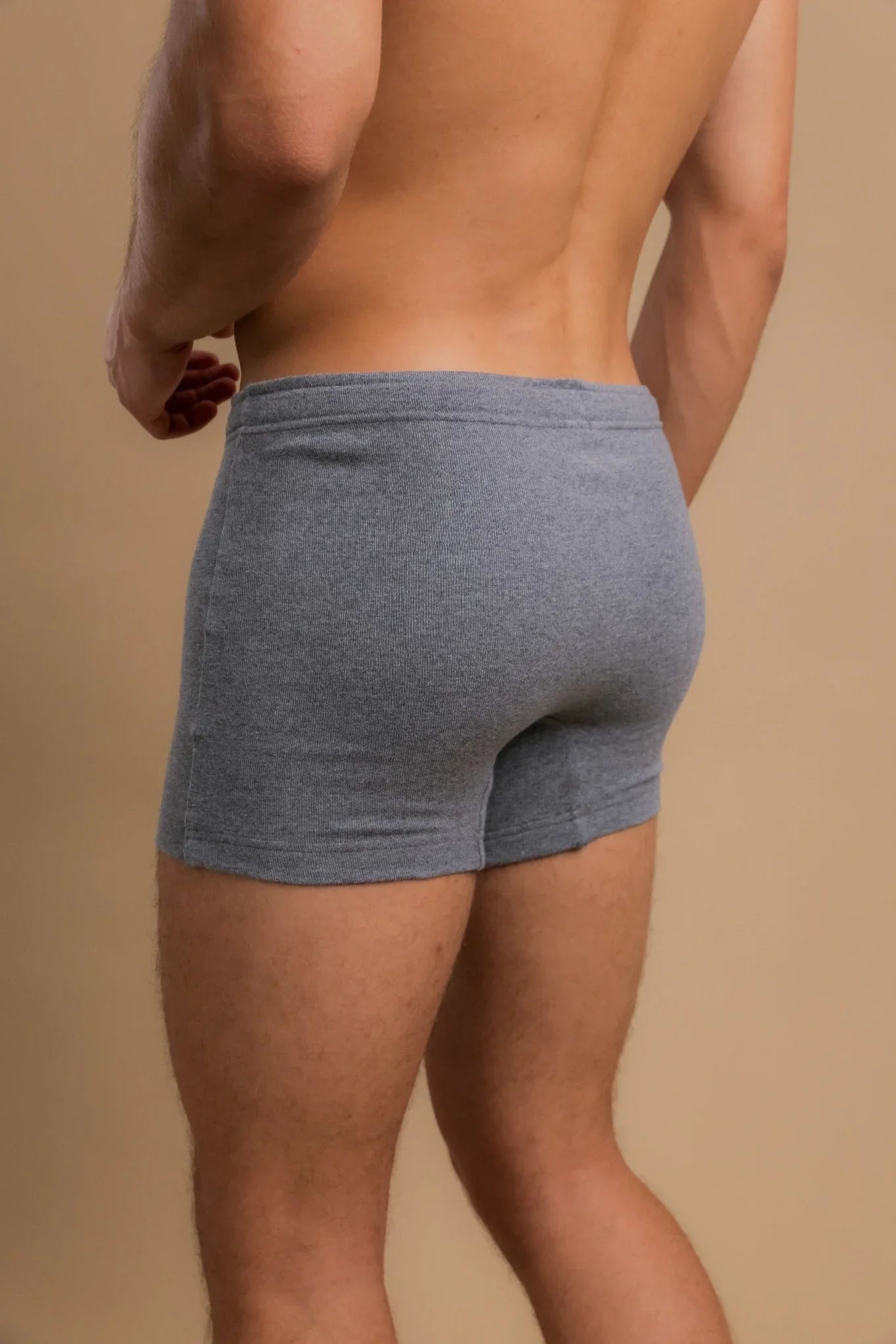 Back view of man wearing gray organic cotton boxer briefs for sensitive skin