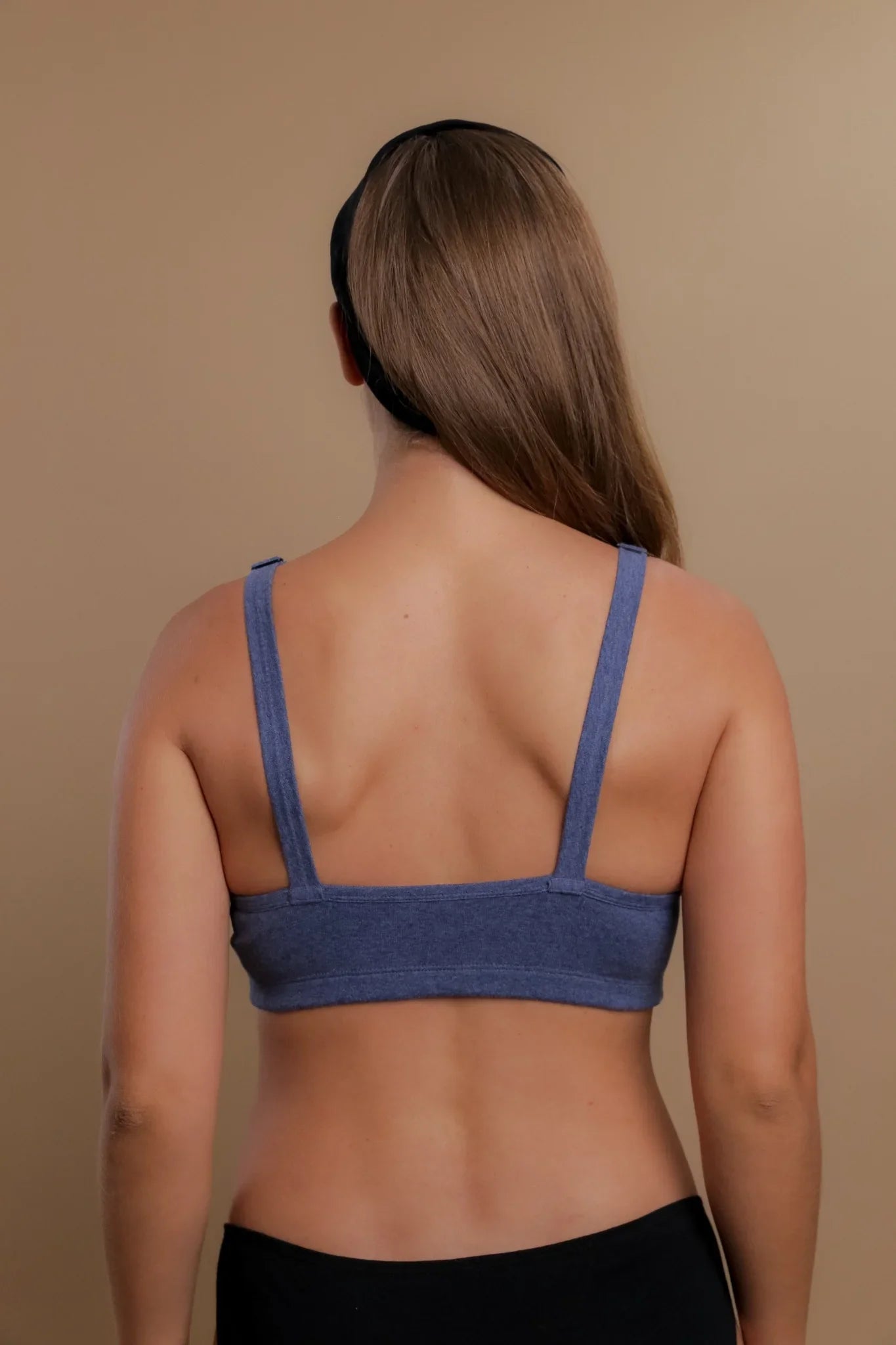 Back view of woman wearing blue hypoallergenic cotton bra by Cottonique